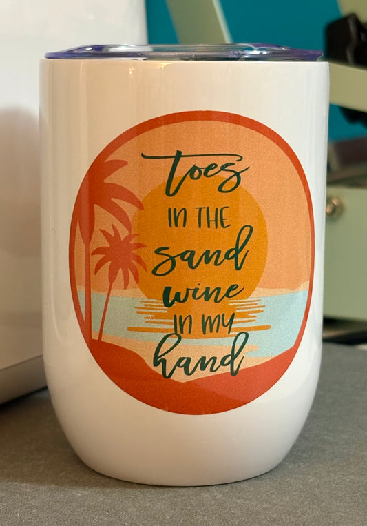 Toes in the sand wine in my hand